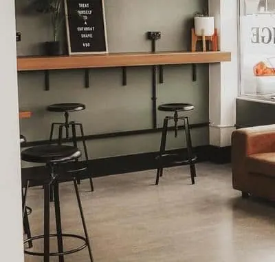 Timber bench and black stools by the window at The Lads Lounge